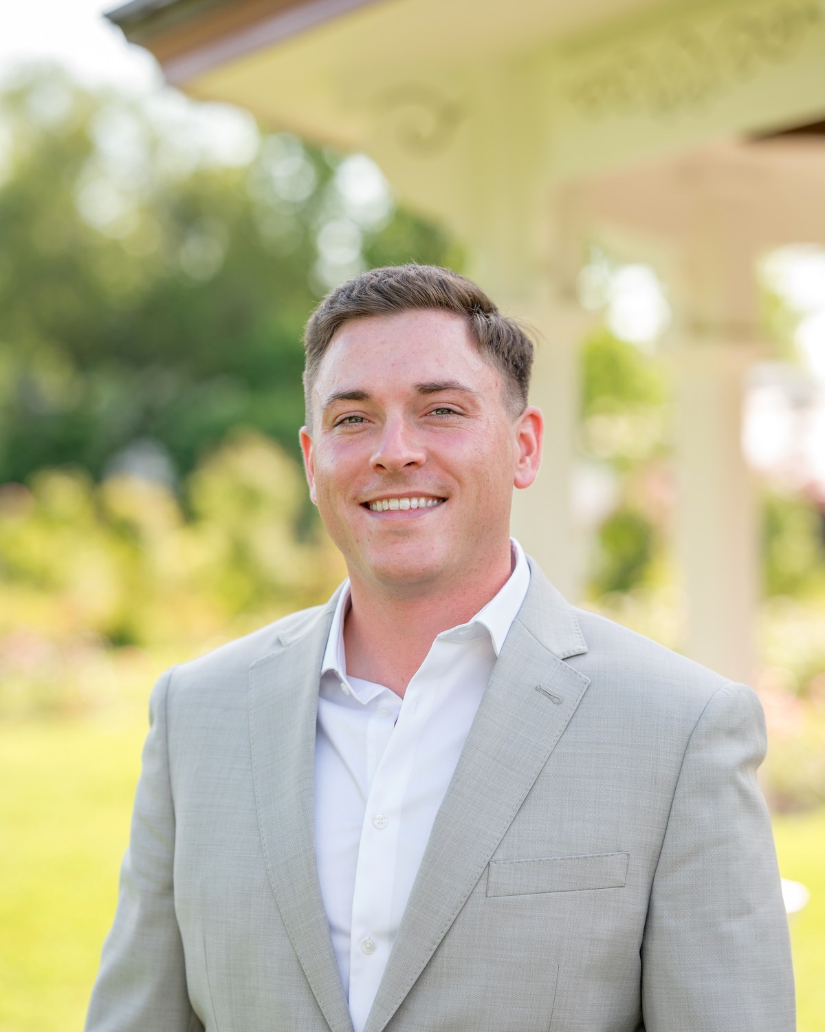 Zachary Day in a light gray suit, photographed outdoors.